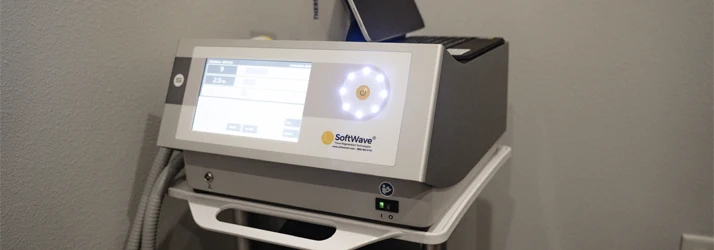 SoftWave therapy device with touchscreen in a chiropractic room